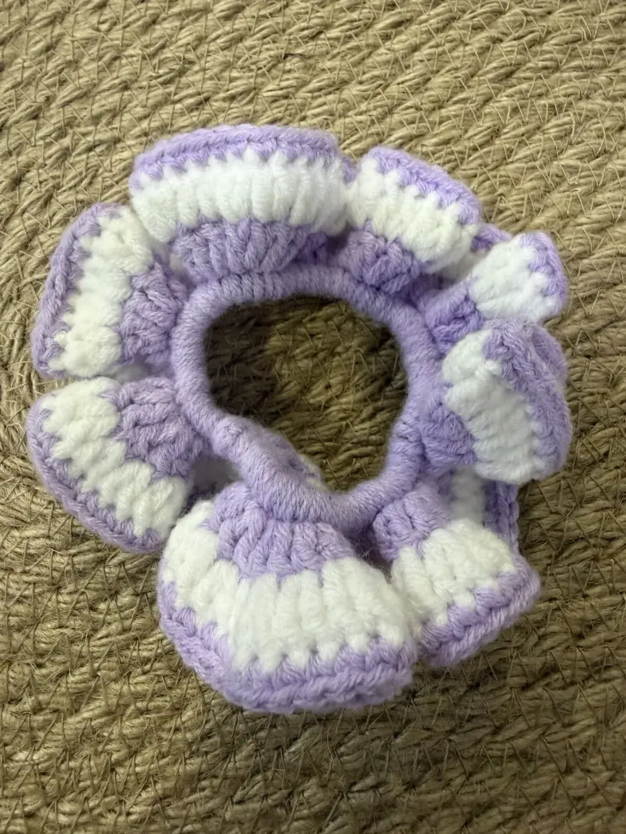 A handmade ruffle scrunchie in lilac and cream stripes.