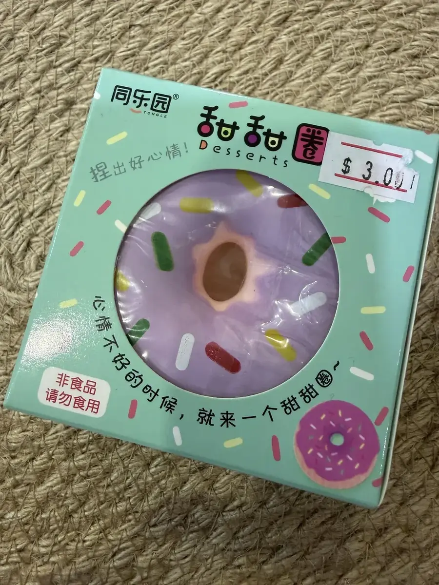 A donut squishy in its box.