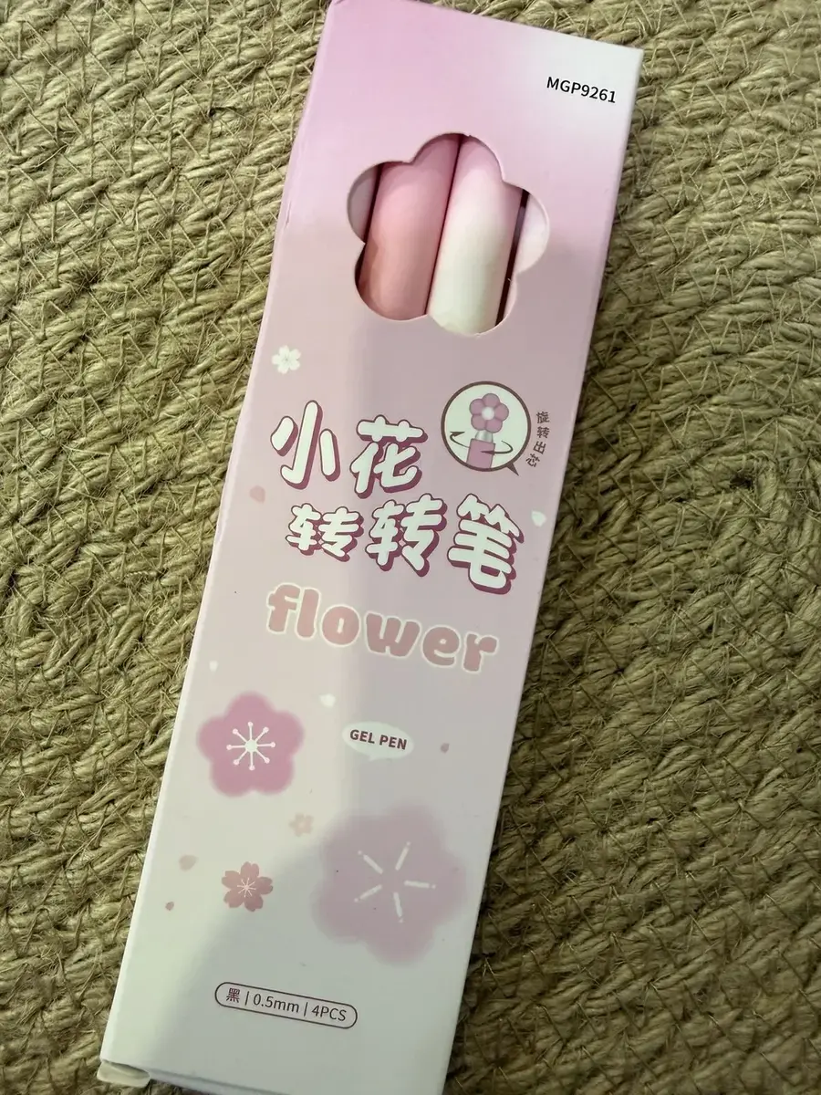 A pink flower pen set in a box.